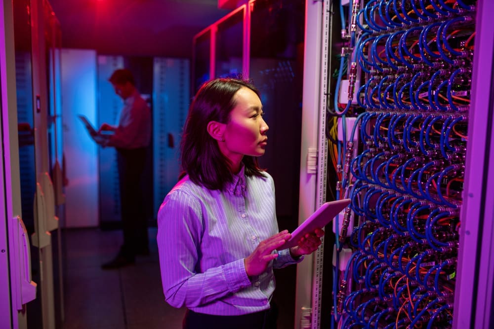 Asian woman maintaining network in server room