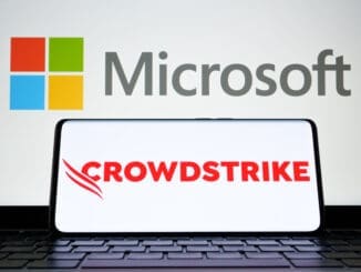 CrowdStrike and Microsoft logo seen on screen of smartphone and laptop. Cybersecurity company behind the global IT outage. Stafford, United Kingdom, July 19, 2024