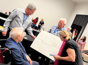 Jerry Peterson, showing Jimmy the Five-Year-Plan on a single page